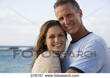 Man and woman hugging on beach View Large Photo Image Stock Photo - Man and woman hugging on beach. Fotosearch