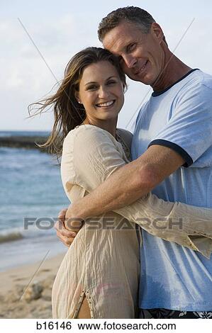 Man and woman hugging on beach View Large Photo Image Stock Photograph - Man and woman hugging on beach. Fotosearch