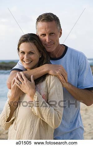 Man and woman hugging outdoors on beach smiling View Large Photo Image Stock Photography - Man and woman hugging outdoors on beach smiling. Fotosearch
