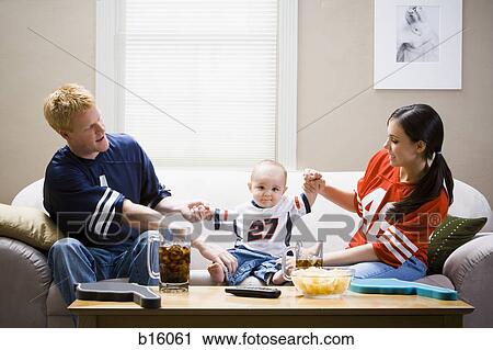 Man and woman on sofa with baby View Large Photo Image Stock Image - Man and woman on sofa with baby. Fotosearch
