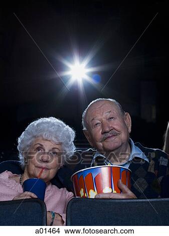 Man and woman watching movie with popcorn View Large Photo Image Picture - Man and woman watching movie with popcorn. Fotosearch