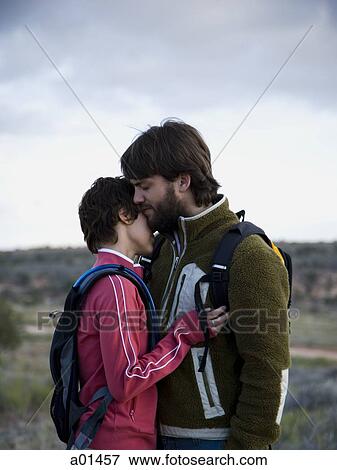 Man and woman with backpacks embracing outdoors View Large Photo Image Stock Photo - Man and woman with backpacks embracing outdoors. Fotosearch
