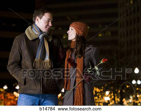 Man and woman with red rose outdoors in winter View Large Photo Image Picture - Man and woman with red rose outdoors in winter. Fotosearch