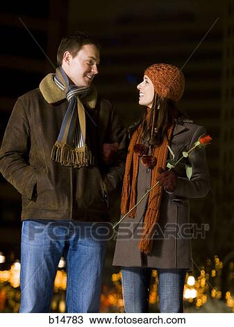 Man and woman with red rose outdoors in winter View Large Photo Image Stock Image - Man and woman with red rose outdoors in winter. Fotosearch