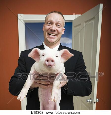 Man at home with piglet smiling View Large Photo Image Stock Photo - Man at home with piglet smiling. Fotosearch