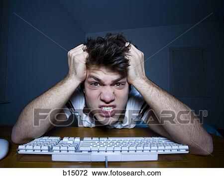 Man at keyboard with hands on head snarling View Large Photo Image Stock Image - Man at keyboard with hands on head snarling. Fotosearch