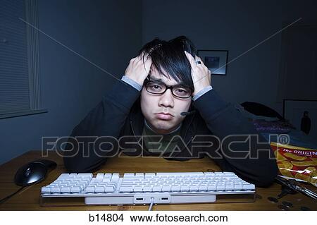 Man at keyboard with headset and hands on head pouting View Large Photo Image Picture - Man at keyboard with headset and hands on head pouting. Fotosearch