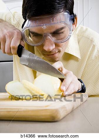 Stock Photograph - man cutting food. Fotosearch