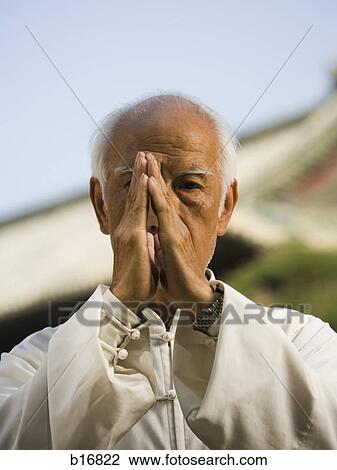 Stock Image - Man doing Kung Fu outdoors. Fotosearch