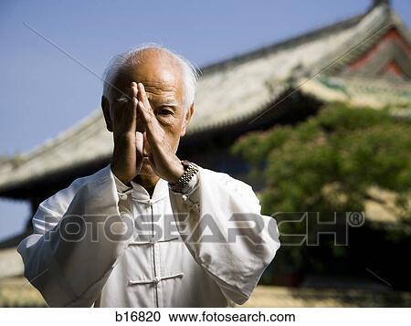 Man doing Kung Fu outdoors with pagoda in background View Large Photo Image Stock Image - Man doing Kung Fu outdoors with pagoda in background. Fotosearch