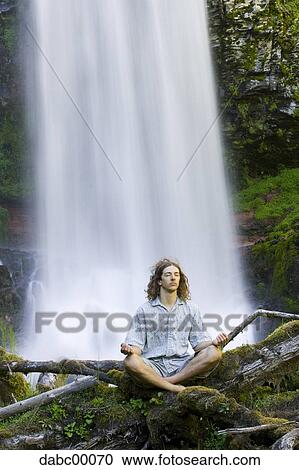 Man doing yoga outdoors by waterfall View Large Photo Image Stock Image - Man doing yoga outdoors by waterfall. Fotosearch