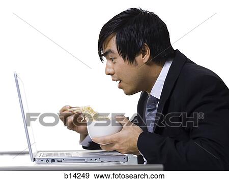 Man eating with laptop View Large Photo Image Stock Photo - Man eating with laptop. Fotosearch