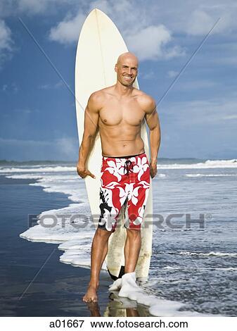 Man holding a surfboard. View Large Photo Image Stock Photo - Man holding a surfboard.. Fotosearch