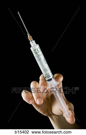 Man holding syringe with twenty dollar bill View Large Photo Image Stock Image - Man holding syringe with twenty dollar bill. Fotosearch
