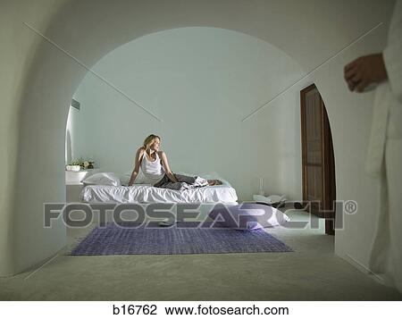 Man in bathrobe and woman on bed smiling View Large Photo Image Stock Image - Man in bathrobe and woman on bed smiling. Fotosearch