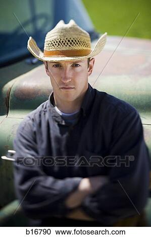 Man in cowboy hat leaning on truck View Large Photo Image Stock Image - Man in cowboy hat leaning on truck. Fotosearch