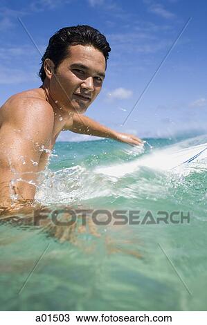 Man in water with surfboard smiling View Large Photo Image Stock Image - Man in water with surfboard smiling. Fotosearch