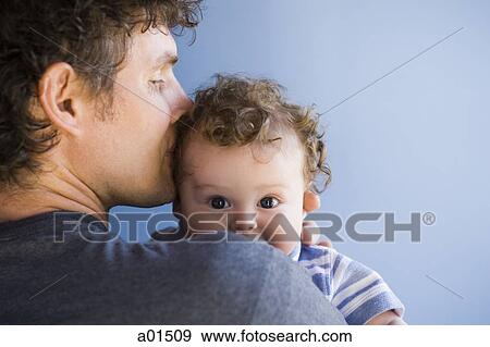 Man kissing baby boy on head View Large Photo Image Stock Photo - Man kissing baby boy on head. Fotosearch