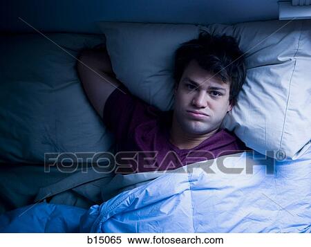 Man lying awake in bed View Large Photo Image Stock Photography - Man lying awake in bed. Fotosearch