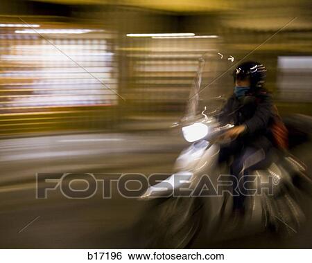 Man on motorcycle with motion blur View Large Photo Image Stock Photograph - Man on motorcycle with motion blur. Fotosearch