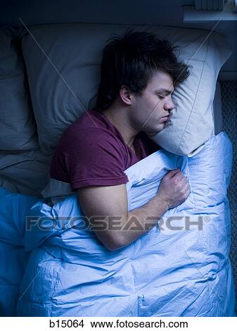 Man sleeping in bed View Large Photo Image Picture - Man sleeping in bed. Fotosearch