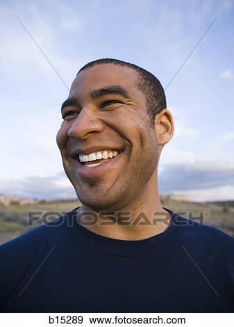 Man smiling outdoors View Large Photo Image Stock Photo - Man smiling outdoors. Fotosearch