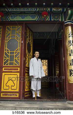 Man standing in ornate doorway in Asia View Large Photo Image Stock Photograph - Man standing in ornate doorway in Asia. Fotosearch
