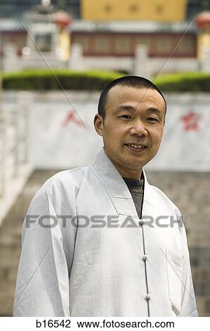 Man standing outdoors smiling View Large Photo Image Stock Image - Man standing outdoors smiling. Fotosearch