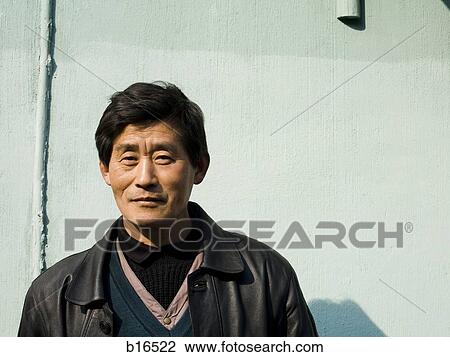 Man standing outdoors View Large Photo Image Stock Image - Man standing outdoors. Fotosearch