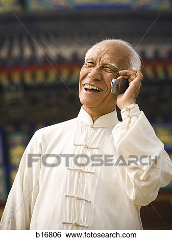 Man talking on cell phone outdoors smiling View Large Photo Image Stock Photograph - Man talking on cell phone outdoors smiling. Fotosearch