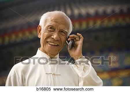Man talking on cell phone outdoors smiling View Large Photo Image Stock Photography - Man talking on cell phone outdoors smiling. Fotosearch