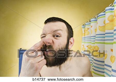 Man with beard in bathroom picking nose View Large Photo Image Stock Photo - Man with beard in bathroom picking nose. Fotosearch