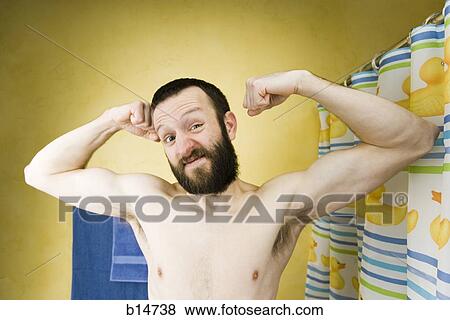 Man with beard stretching and flexing in bathroom View Large Photo Image Stock Photo - Man with beard stretching and flexing in bathroom. Fotosearch