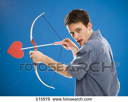 Man with bow and arrow with heart View Large Photo Image Stock Photo - Man with bow and arrow with heart. Fotosearch