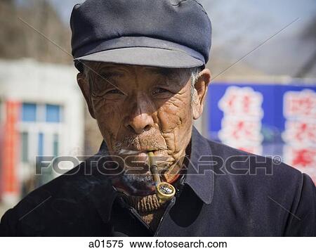 Man with cap smoking pipe outdoors View Large Photo Image Stock Photography - Man with cap smoking pipe outdoors. Fotosearch