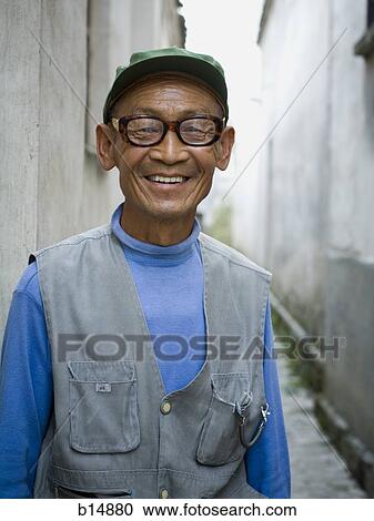 Man with eyeglasses outdoors smiling View Large Photo Image Stock Image - Man with eyeglasses outdoors smiling. Fotosearch