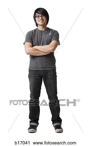 Stock Image - Man with eyeglasses standing with arms crossed smiling. Fotosearch