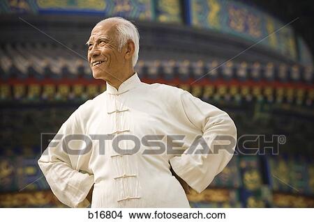 Man with hands on hips looking away smiling View Large Photo Image Picture - Man with hands on hips looking away smiling. Fotosearch