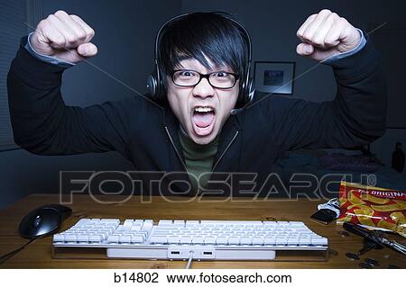 Man with headset making fists and sitting at keyboard View Large Photo Image Stock Image - Man with headset making fists and sitting at keyboard. Fotosearch