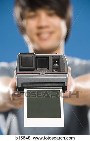 Man with instant camera and blank photo View Large Photo Image Stock Photo - Man with instant camera and blank photo. Fotosearch
