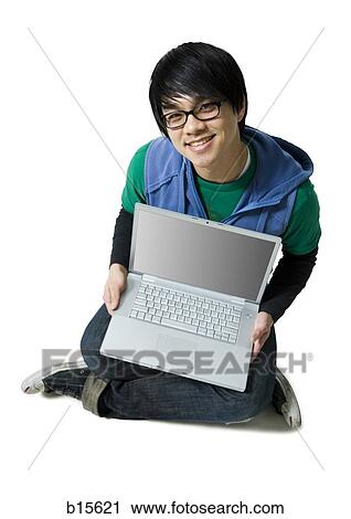 Man with laptop sitting cross legged smiling View Large Photo Image Stock Image - Man with laptop sitting cross legged smiling. Fotosearch