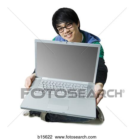 Man with laptop sitting cross legged smiling View Large Photo Image Stock Image - Man with laptop sitting cross legged smiling. Fotosearch