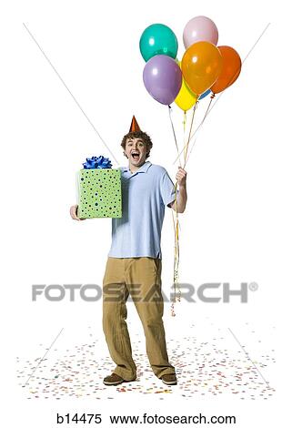 Man with party hat holding balloons and gift box View Large Photo Image Stock Photography - Man with party hat holding balloons and gift box. Fotosearch