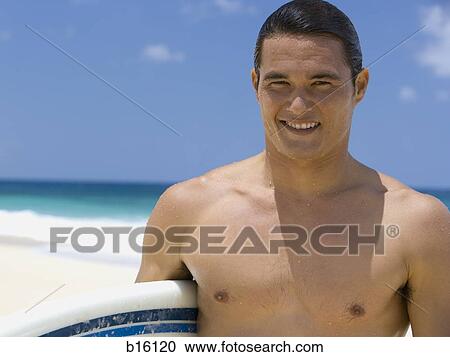Man with surfboard on beach smiling View Large Photo Image Stock Image - Man with surfboard on beach smiling. Fotosearch