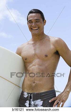 Man with surfboard on beach smiling View Large Photo Image Stock Image - Man with surfboard on beach smiling. Fotosearch
