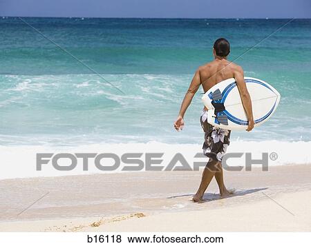 Man with surfboard on beach View Large Photo Image Stock Photo - Man with surfboard on beach. Fotosearch