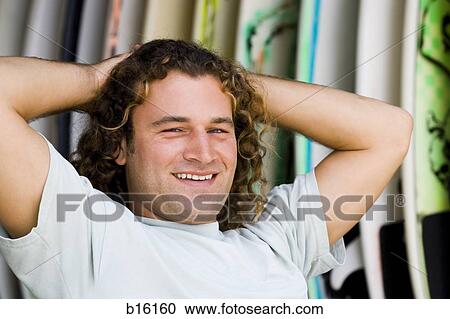 Man with surfboards outdoors smiling View Large Photo Image Stock Image - Man with surfboards outdoors smiling. Fotosearch