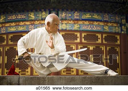 Man with sword doing Kung Fu View Large Photo Image Stock Photography - Man with sword doing Kung Fu. Fotosearch