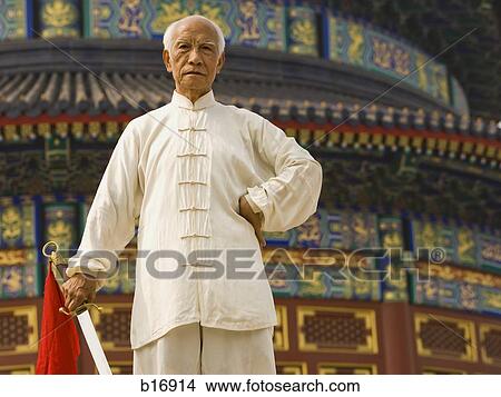 Man with sword outdoors View Large Photo Image Picture - Man with sword outdoors. Fotosearch