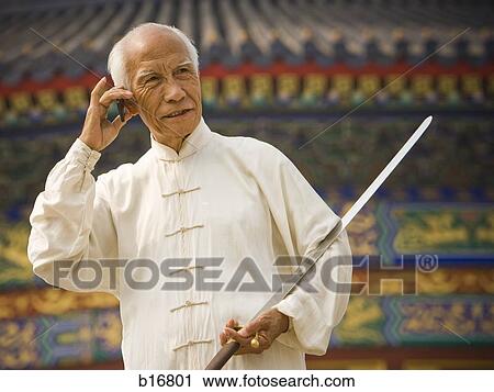 Man with sword talking on cell phone View Large Photo Image Stock Image - Man with sword talking on cell phone. Fotosearch